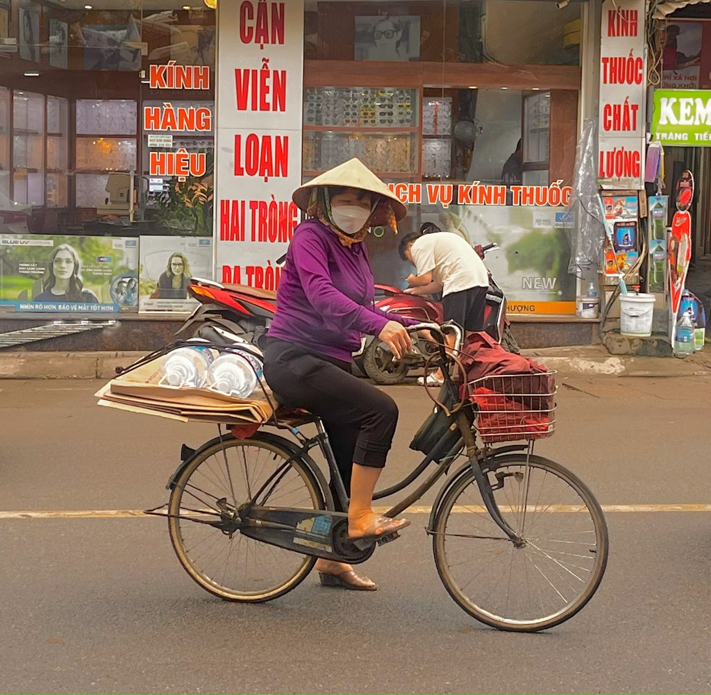 A Vietnamese female wearing a Nón Lá  (the traditional conical hat)